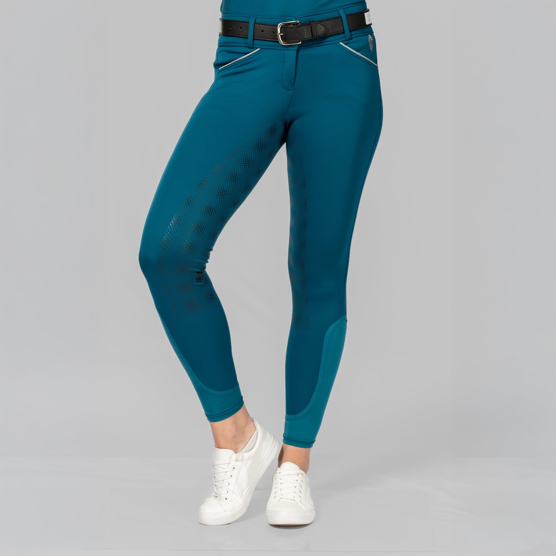 Front view of a female model wearing the Black/Glacier Blue Equinavia Estelle Hand Beaded Belt over petrol breeches on a plain background