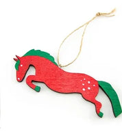 Green and red jumping horse wooden ornament with twine shown on plain white background