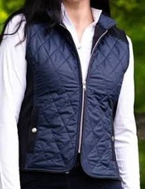 Navy and black quilted vest with silver zipper and accents shown on model on natural backdrop