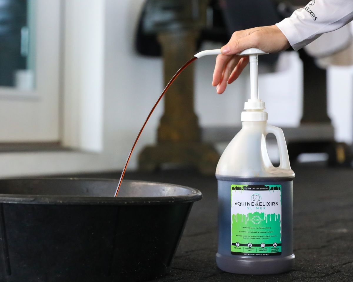 View of a model pumping Equine Elixirs Slimer into a horse's feed bowl