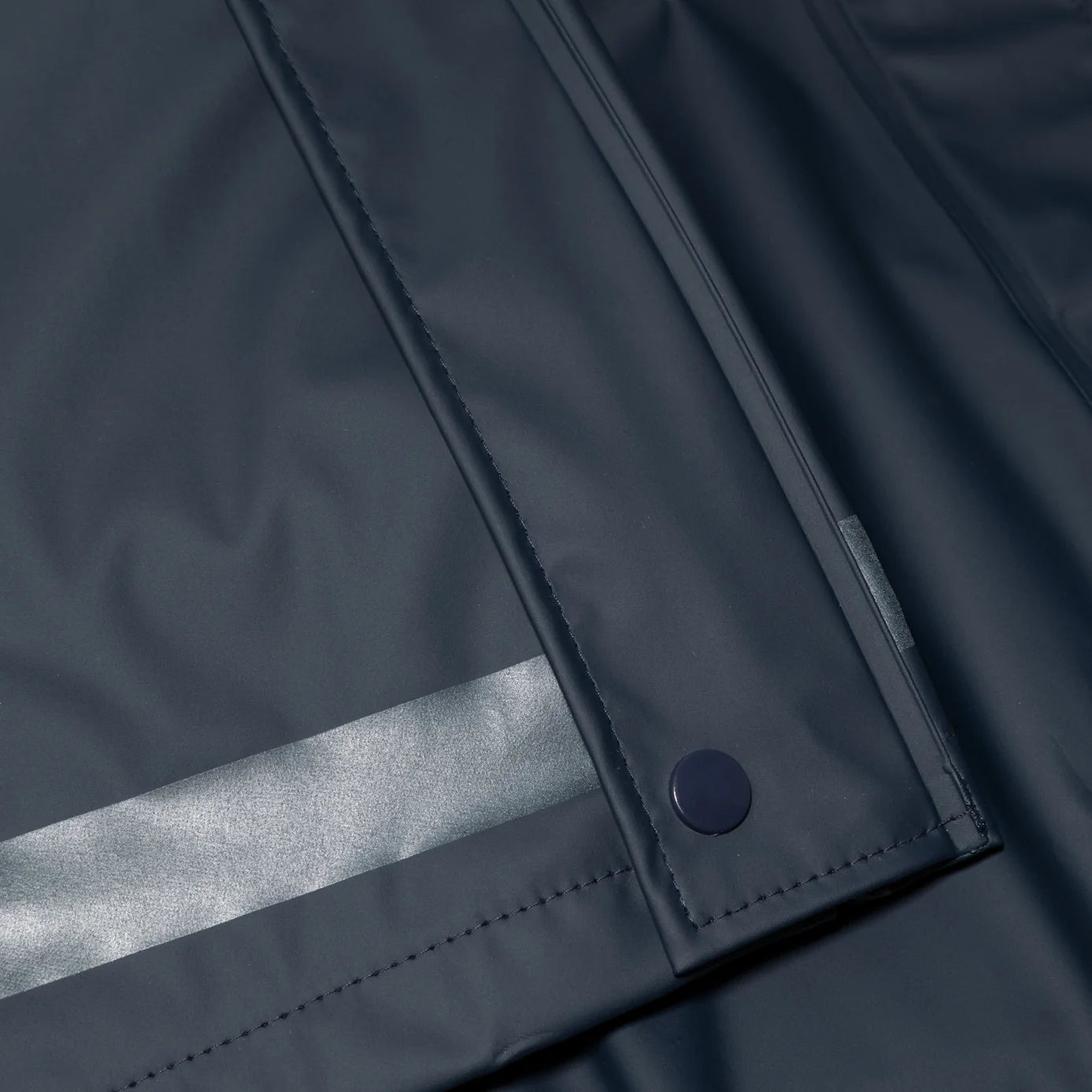 Closeup view of the Navy Horze Hazel Womens Long Raincoat on a plain background showing the reflective stripes