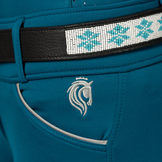 Close-up view of the Black/Glacier Blue Equinavia Estelle Hand Beaded Belt over petrol breeches