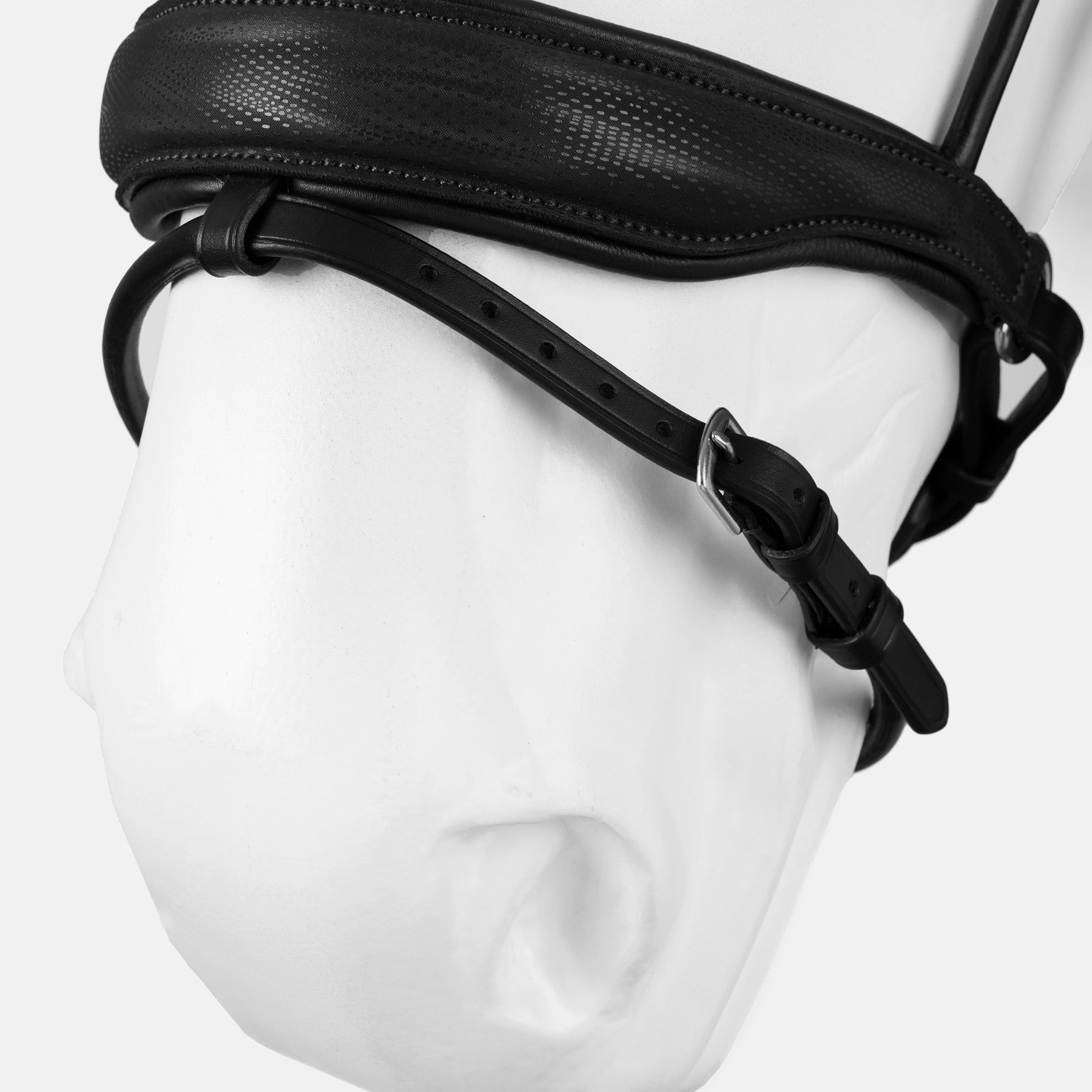 Close-up view of the nose of a white horse mannequin wearing the black Horze Montrose Dressage Bridle on a white background
