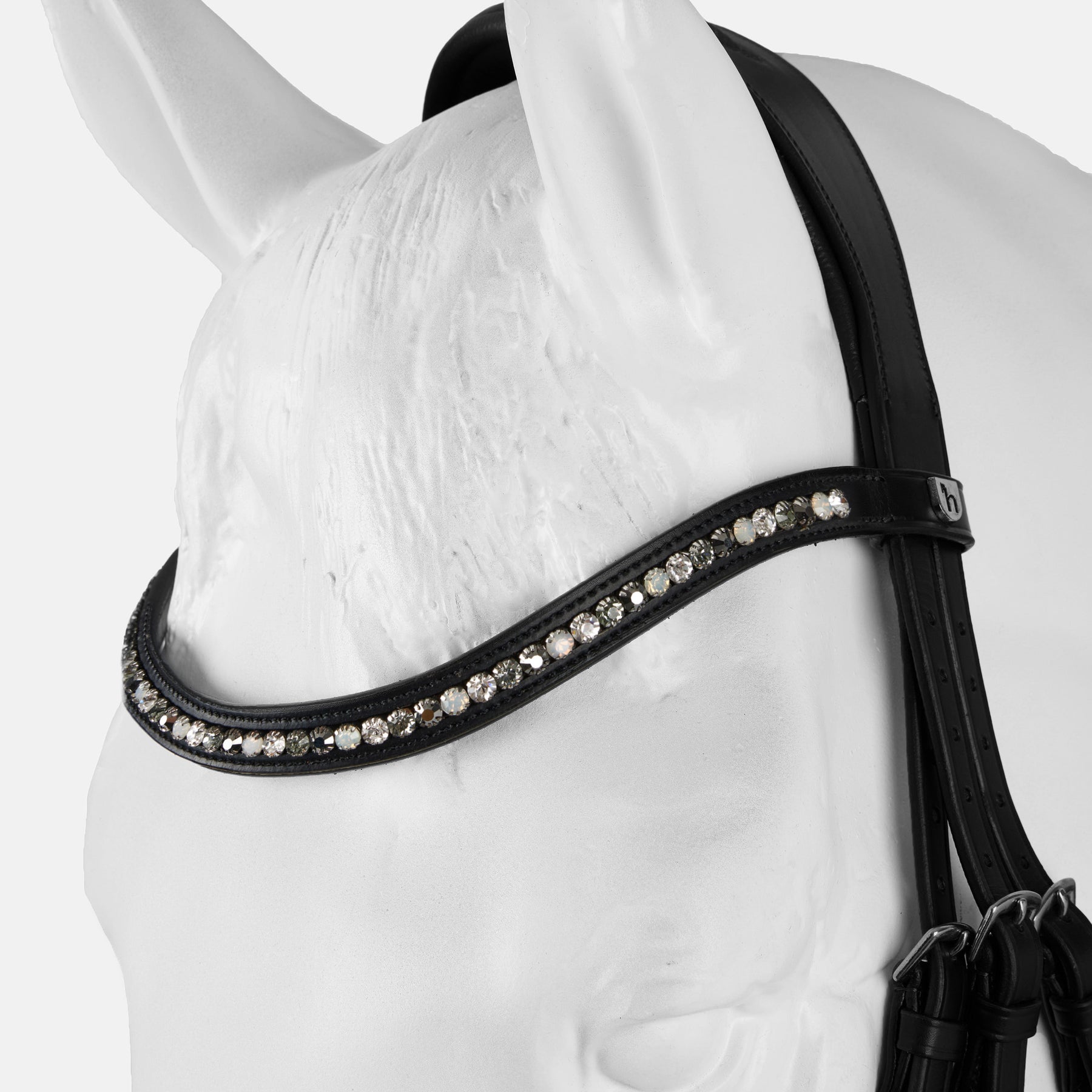 Close-up view of the poll of a white horse mannequin wearing the black Horze Montrose Dressage Bridle on a white background