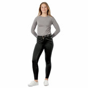 Full body front view of a female model wearing the Black Equinavia Astrid Winter Full Seat Breeches and gray top on a white background