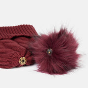 View of the removable pom on the Spiced Apple Horze Anni Knitted Hat on a white background