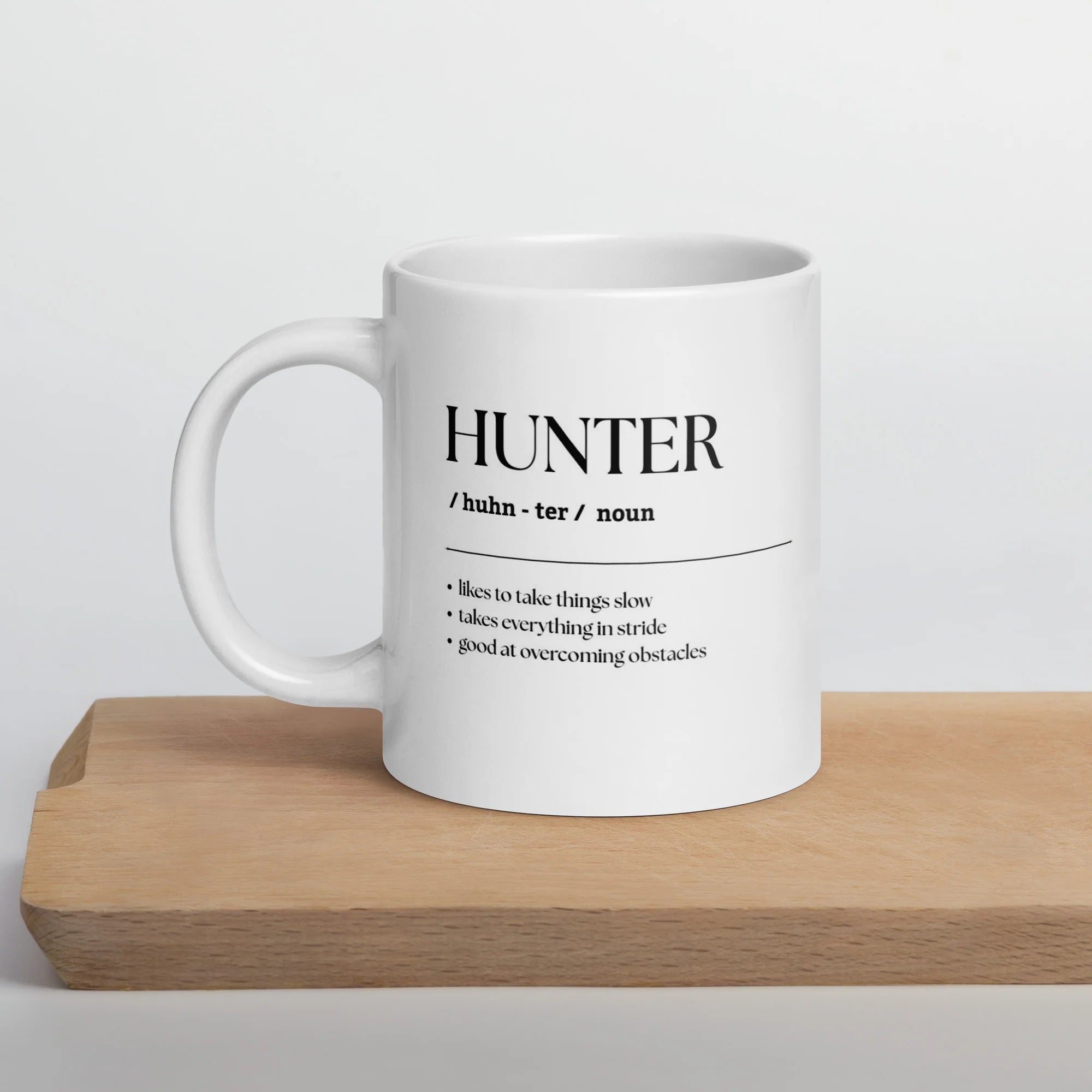 Front view of the Hunter Unsustainable Equestrian Jumbo Mug on a wood board on a plain background