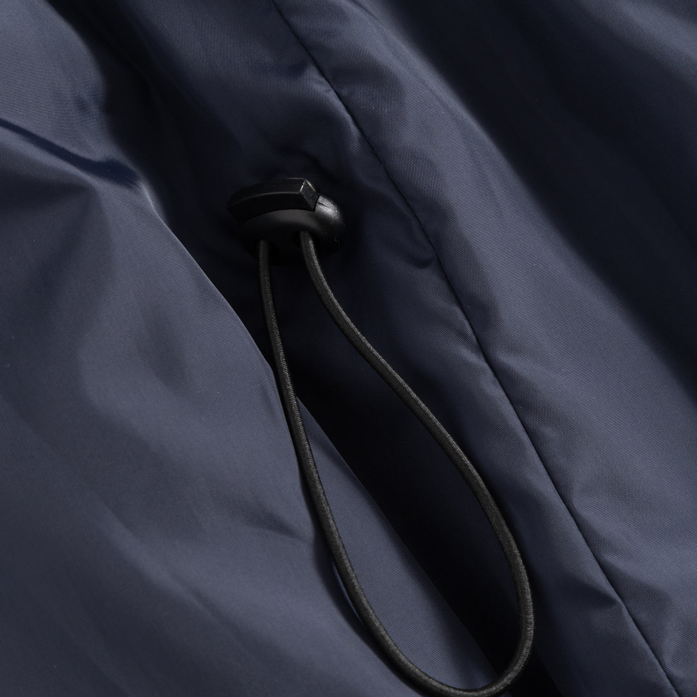 Closeup view of the Seaborne Navy Horze Paloma Kids Insulated Long Coat showing the sizing pull