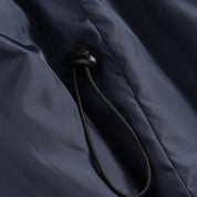 Closeup view of the Seaborne Navy Horze Paloma Kids Insulated Long Coat showing the sizing pull