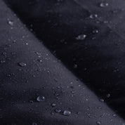 Closeup view of the Seaborne Navy Horze Paloma Kids Insulated Long Coat showing the waterproof fabric