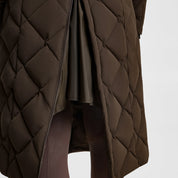 Close-up view of the back gusset on the Turkish Coffee B Vertigo Gem Waxed Padded Long Coat on a white background