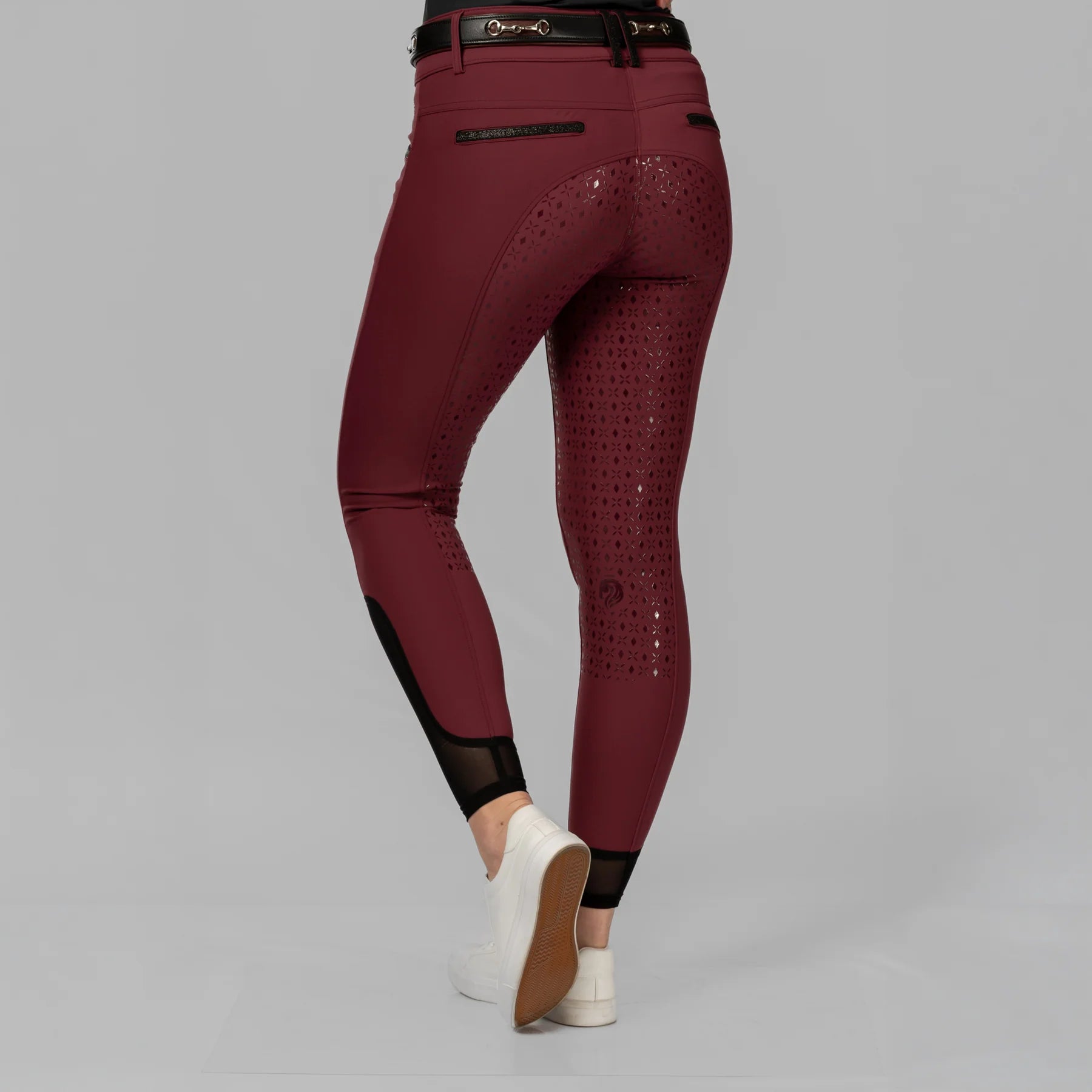 Back view of a model wearing the Burgundy Equinavia Kristina Full Seat Breeches on a plain background