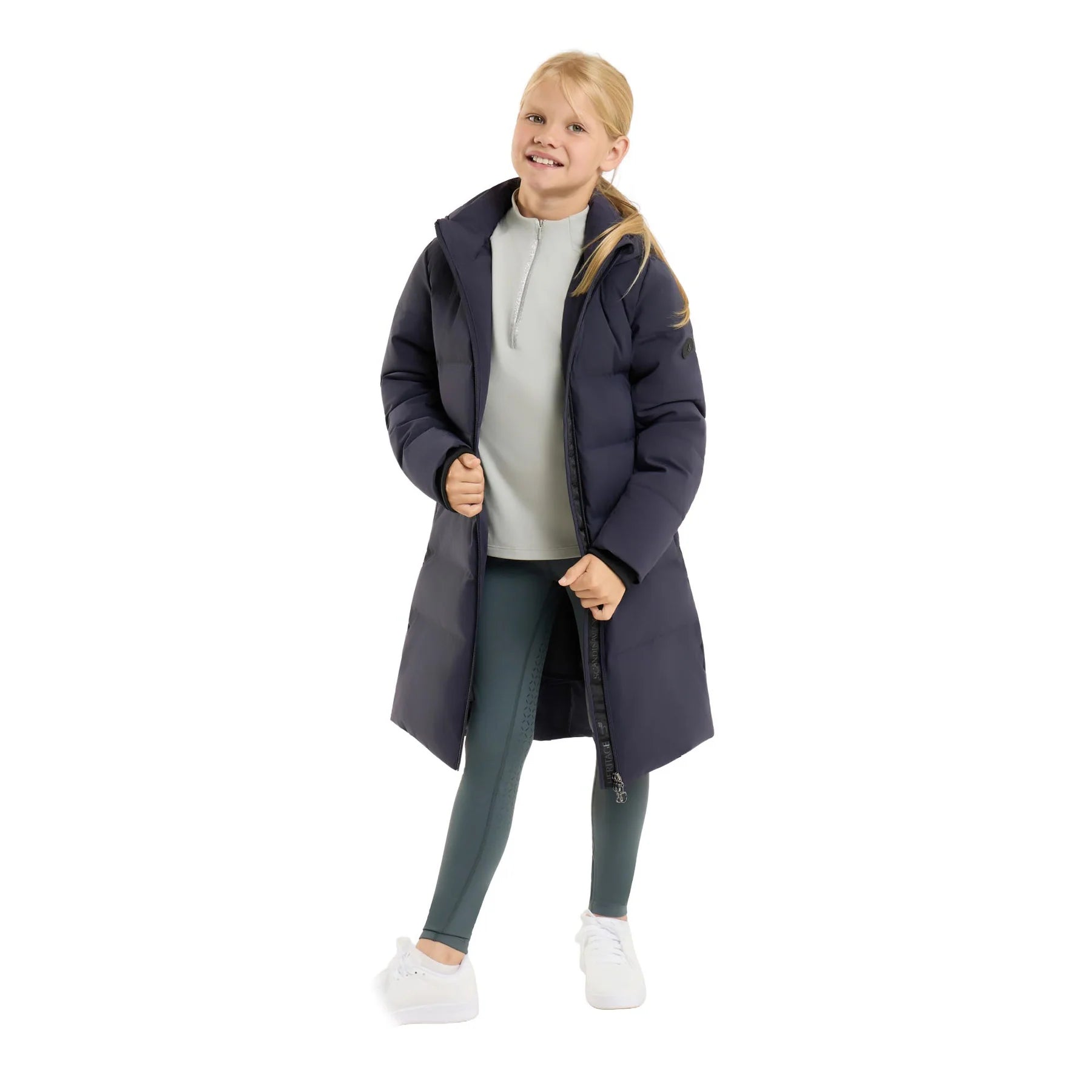 Front view of a young model wearing the Seaborne Navy Horze Paloma Kids Insulated Long Coat on a plain background