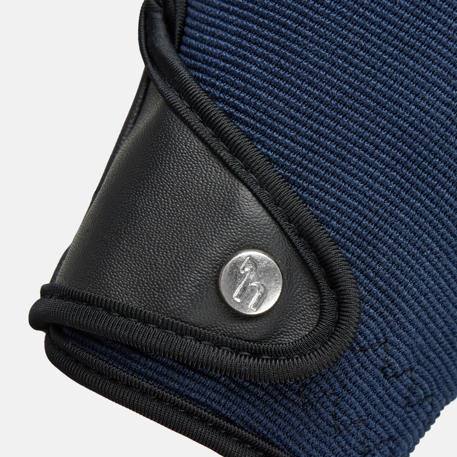 Close-up view of the wrist closure on a Seaborne Navy Horze Romy Winter Riding Glove on a plain background